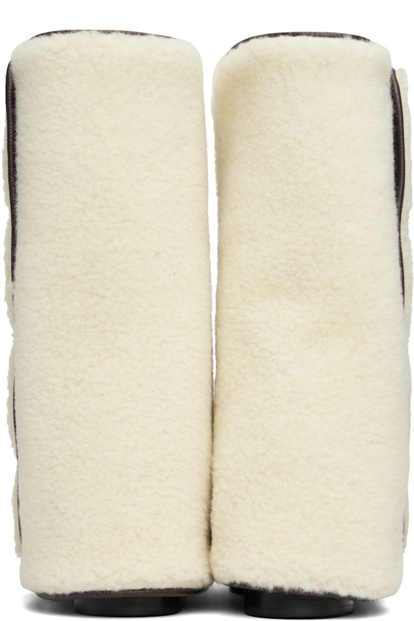 Mid-calf grained leather boots.

· Detachable wool fleece overlay
· Square toe
· Elasticized gusset at sides
· Logo printed at outer side
· Buffed leather lining
· Stacked leather heel with rubber injection
· Leather sole
· Heel: H2.75"

Supplier color: Brown