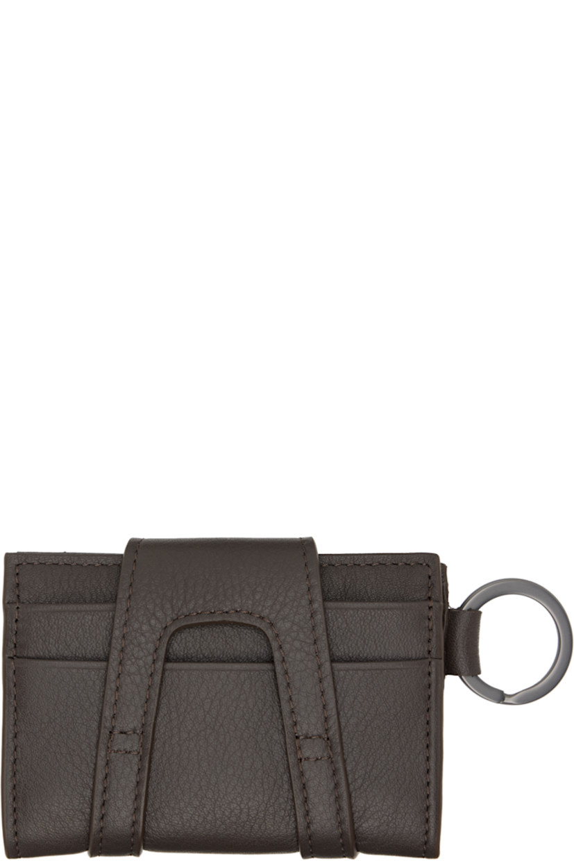 Grained nappa calfskin card holder.

· Logo hardware at face
· Logo-engraved keyring at side
· Press-stud closure
· Six card slots
· H3" x W4"

Supplier color: Chocolate