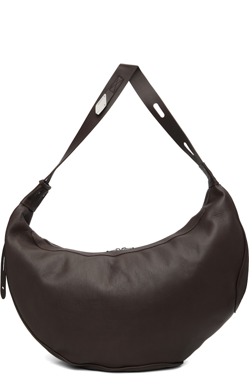 Grained nappa calfskin messenger bag.

· Adjustable crossbody strap
· Two-way zip closure
· Zip pocket at interior
· Plain-woven lining
· H14" x W23" x D8"

Supplier color: Chocolate