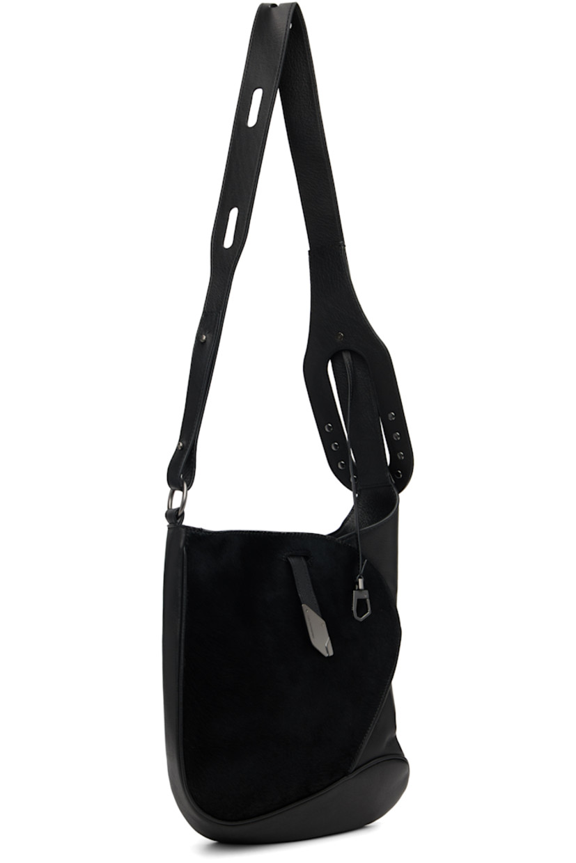 Grained nappa calfskin and hair-on-leather messenger bag.

· Clasp fastening at adjustable crossbody strap
· Pinched seam at face
· Tab-slot closure
· Zip pocket at interior
· Plain-woven lining
· H12" x W10" x D2.75"

Supplier color: Black obsidian/Pitch black