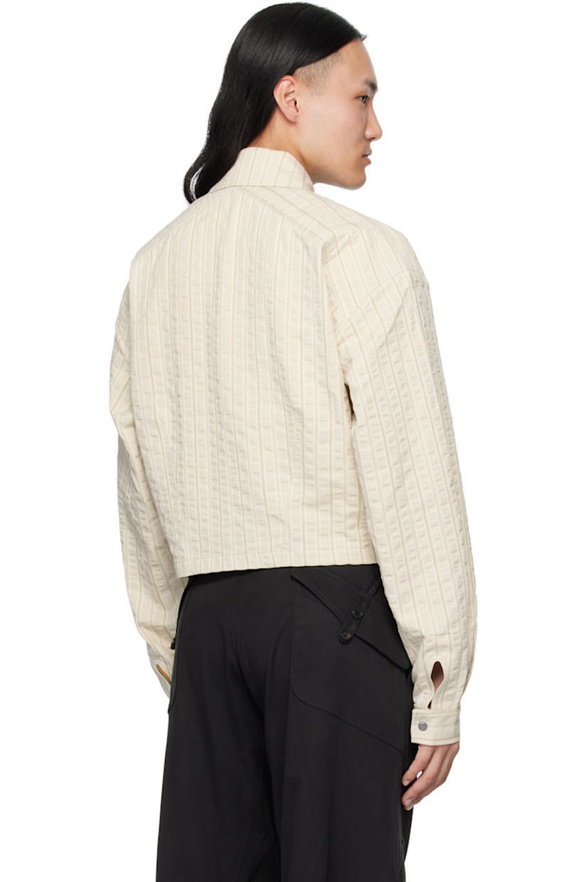 Woven cotton shirt.

· Woven stripes throughout
· Spread collar
· Press-stud closure 
· Overlayed panels at front
· Cropped hem
· Adjustable press-stud cuffs

Supplier color: Ivory Hunter Stripe