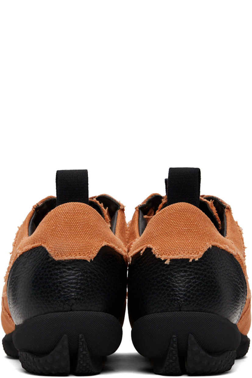 Low-top cotton canvas sneakers.

· Raw edges and fading throughout
· Lace-up closure
· Pull-loop with logo hardware at tongue
· Padded tongue and collar
· Pull-loop at heel collar
· Buffed leather lining
· Treaded rubber sole

Supplier color: Beech orange