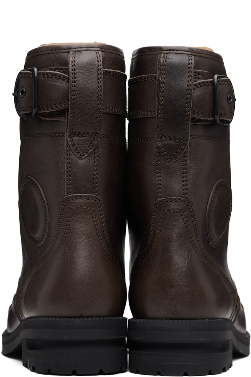 Mid-calf grained leather boots.

· Lace-up closure
· Logo graphic embroidered at vamp
· Logo embossed at tongue
· Pin-buckle strap at outer side
· Serrated edge at welt
· Treaded Vibram® rubber sole

Supplier color: Dark brown