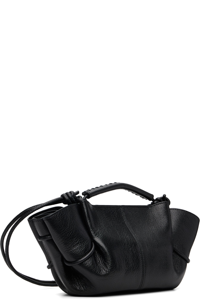 Grained lambskin top handle bag. 

· Whipstitching at rolled carry handle
· Knotted adjustable crossbody strap
· Pleats at sides
· Magnetic closure
· Goatskin lining
· H5.5" x W12" x D4"

Supplier color: Black