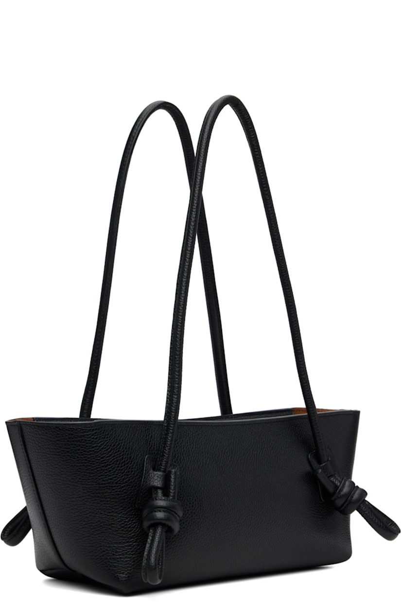 Handcrafted pebble-grained calfskin shoulder bag.

· Knotted detailing at fixed shoulder straps
· Zip closure
· Card slot at interior 
· Unlined
· Antiqued silver-tone hardware
· H5.5" x W16" x D5"

Supplier color: Black