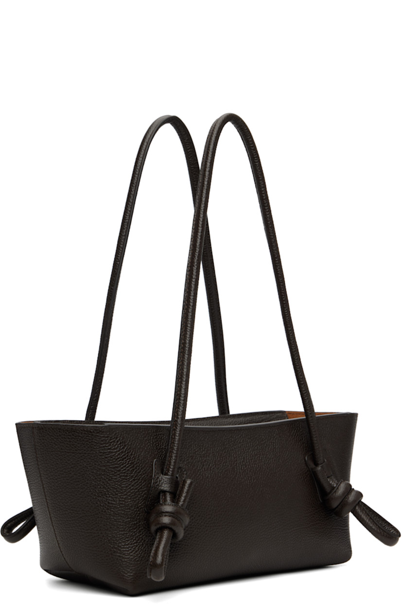Handcrafted pebble-grained calfskin shoulder bag.

· Knotted detailing at fixed shoulder straps
· Zip closure
· Card slot at interior 
· Unlined
· Antiqued silver-tone hardware
· H5.5" x W16" x D5"
 
Supplier color: Dark brown