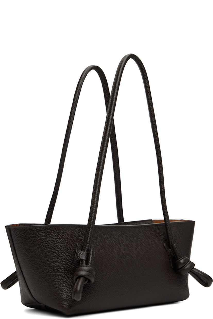 Handcrafted pebble-grained calfskin shoulder bag.

· Knotted detailing at fixed shoulder straps
· Zip closure
· Card slot at interior 
· Unlined
· Antiqued silver-tone hardware
· H5.5" x W16" x D5"
 
Supplier color: Dark brown