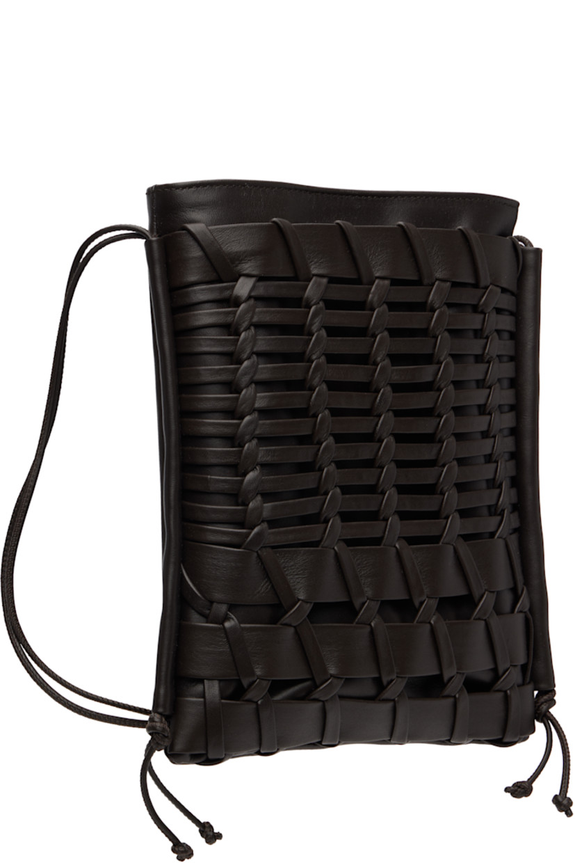 Buffed calfskin shoulder bag.

· Adjustable crossbody strap
· Hand-woven patch pocket at face
· Magnetic closure
· Patch pocket at interior
· Organic cotton canvas lining
· H9" x W7.25" x D1"

Supplier color: Dark brown