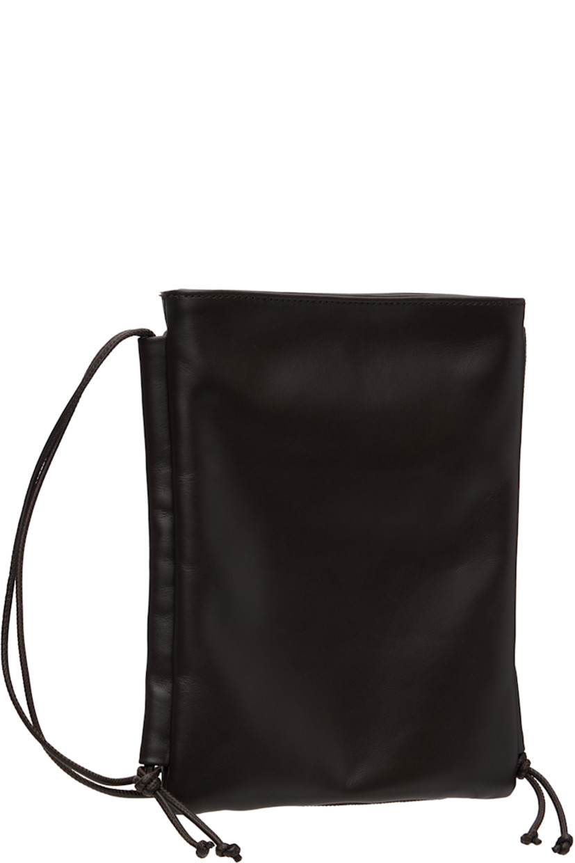 Buffed calfskin shoulder bag.

· Adjustable crossbody strap
· Hand-woven patch pocket at face
· Magnetic closure
· Patch pocket at interior
· Organic cotton canvas lining
· H9" x W7.25" x D1"

Supplier color: Dark brown
