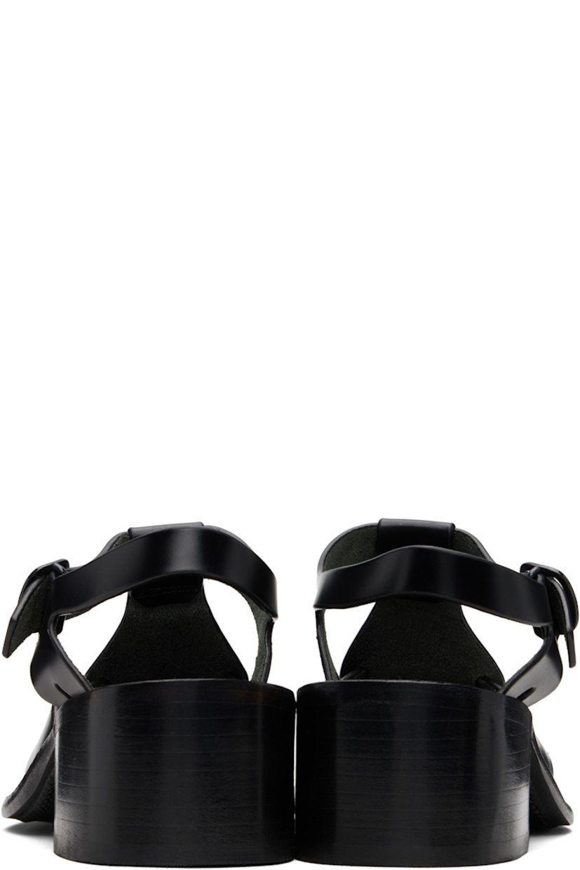 Handcrafted buffed calfskin heeled sandals.

· Cutouts throughout
· Woven detailing at vamp
· Pin-buckle ankle strap
· Logo embossed at footbed
· Stacked calfskin block heel
· Calfskin sole
· Heel: H2"

Supplier color: Black
