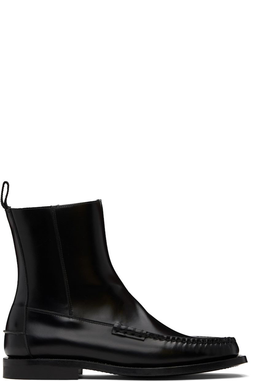 Ankle-high polished calfskin boots.

· Blanket stitching at moc toe
· Zip closure at inner side
· Pull-loop at heel collar
· Pinched seam at heel counter
· Topstitching at welt
· Stacked leather heel with rubber injection
· Calfskin sole

Supplier color: Black