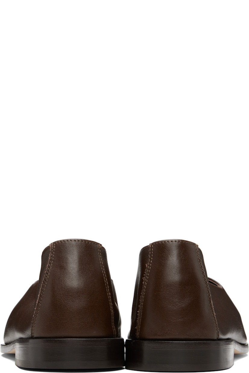 Handcrafted grained calfskin loafers.

· Moc toe
· Suede interior
· Stacked calfskin heel
· Calfskin sole

Supplier color: Dark brown