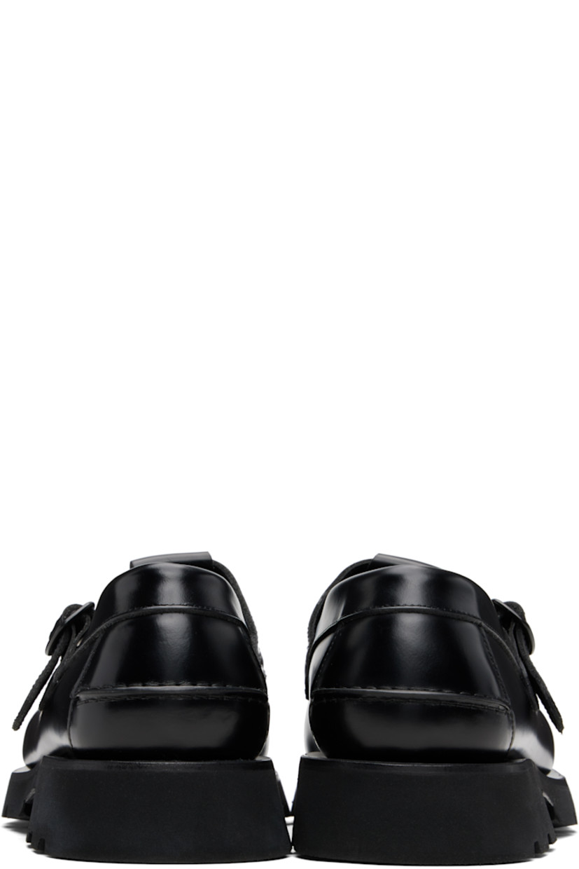 Handcrafted buffed calfskin loafers.

· Moc toe
· Woven detailing at vamp
· Pin-buckle strap
· Pinched seam at heel counter
· Suede interior
· Treaded rubber sole

Supplier color: Black