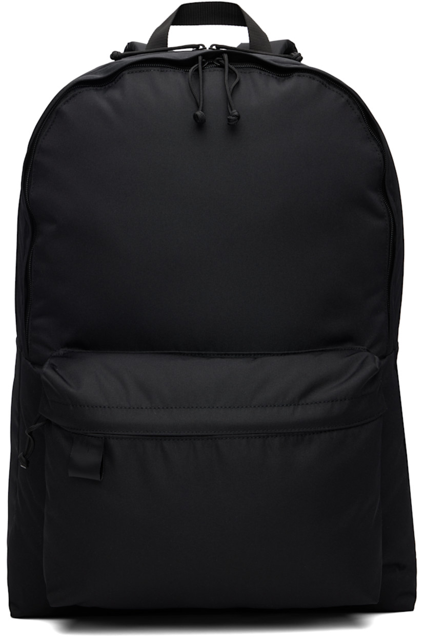 Canvas backpack.

· Fixed carry handle
· Adjustable padded shoulder straps
· Zip pockets at face
· Logo flag at face
· Two-way zip closure
· Laptop compartment and patch pockets at interior
· H22" x W18" x D11"

Part of the N.HOOLYWOOD x PORTER collaboration.

Supplier color: Black