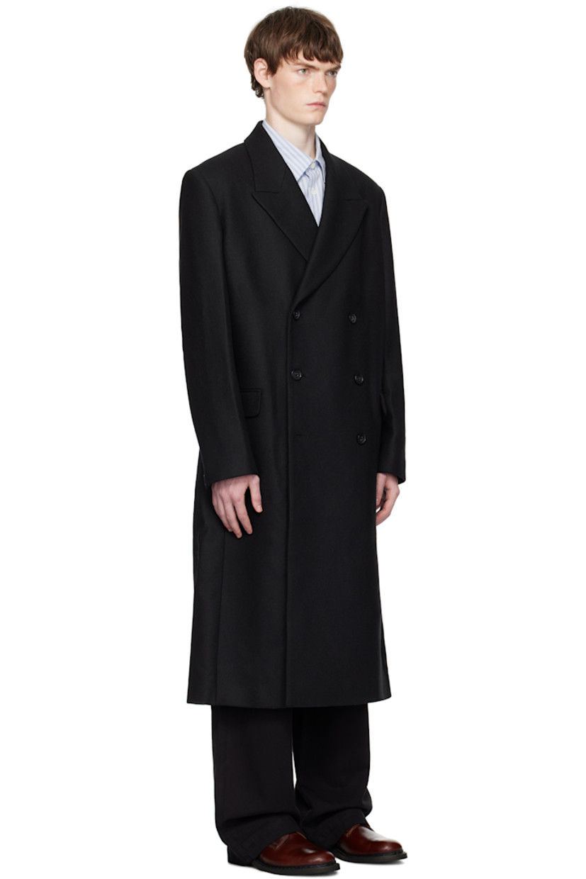 Felted recycled wool-blend twill coat.

· Peaked lapel
· Double-breasted button closure
· Flap pockets at waist
· Padded shoulders
· Button fastening at cuffs
· Central vent at back hem
· Welt pockets at interior
· Full satin lining
· Horn hardware

Supplier color: Black twill