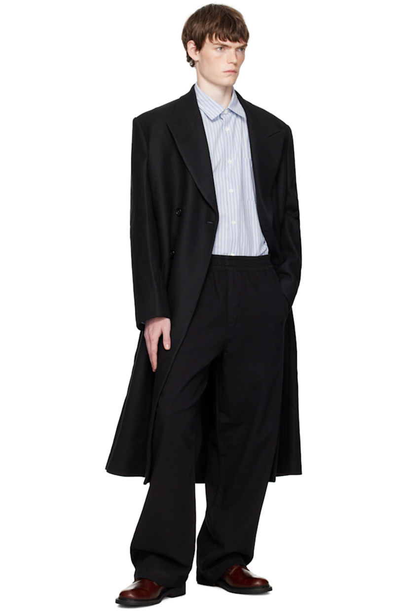 Felted recycled wool-blend twill coat.

· Peaked lapel
· Double-breasted button closure
· Flap pockets at waist
· Padded shoulders
· Button fastening at cuffs
· Central vent at back hem
· Welt pockets at interior
· Full satin lining
· Horn hardware

Supplier color: Black twill