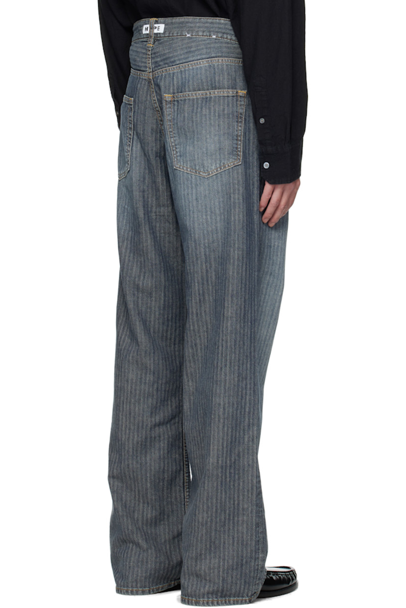 Non-stretch pre-consumer cotton-blend denim jeans. 

· Fading and herringbone pattern throughout 
· Garment-dyed 
· Wide-leg 
· Belt loops
· Five-pocket styling
· Button fly 
· Dropped inseam
· Logo patch at back waistband
· Contrast stitching in tan 

Supplier color: Mid blue herringbone