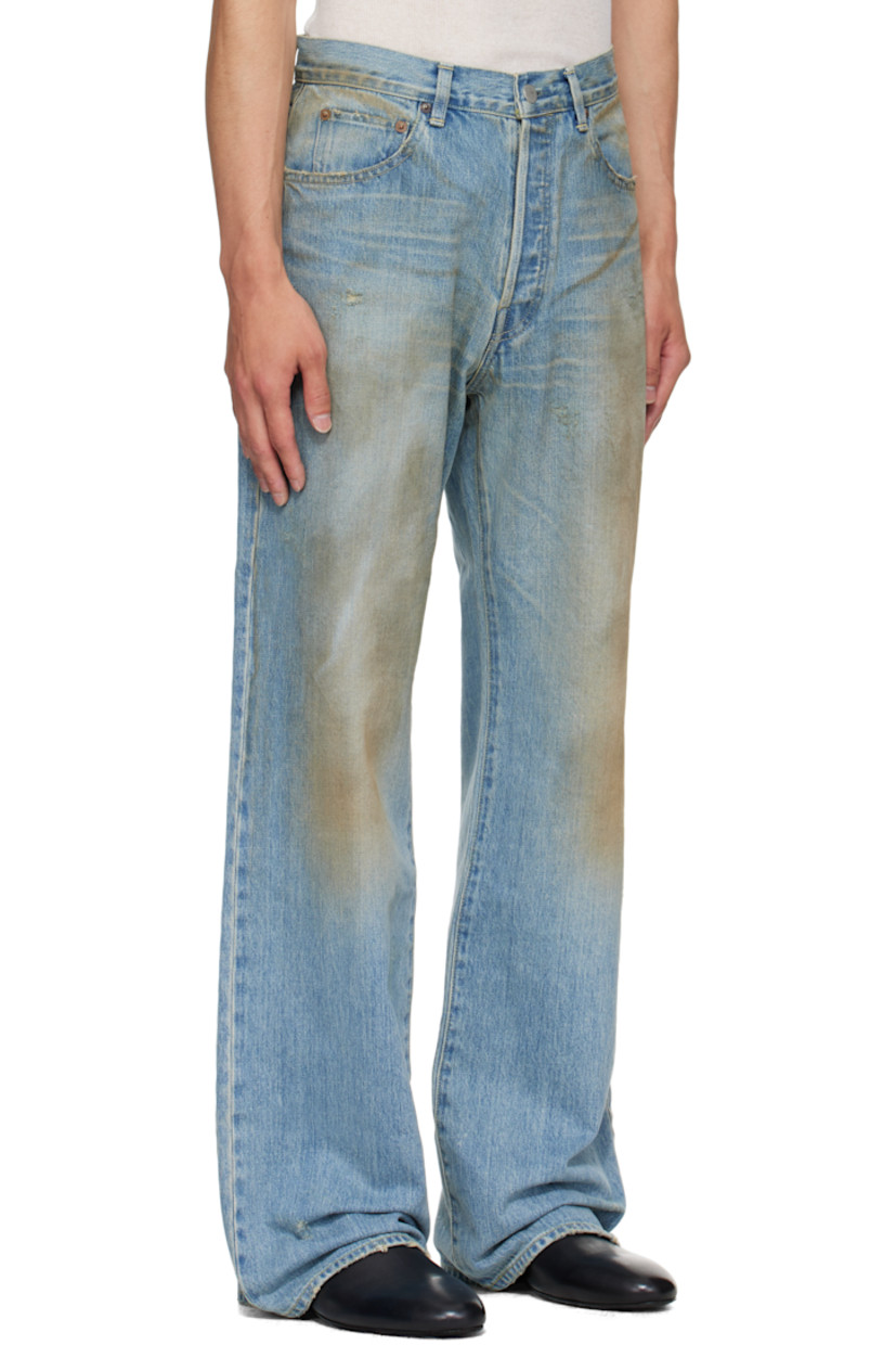 Non-stretch denim jeans.

· Fading, whiskering, smudging, and distressing throughout 
· Flared
· Belt loops
· Five-pocket styling 
· Button fly 
· Suede patch at back waistband
· Contrast stitching in yellow 

Supplier color: Indigo