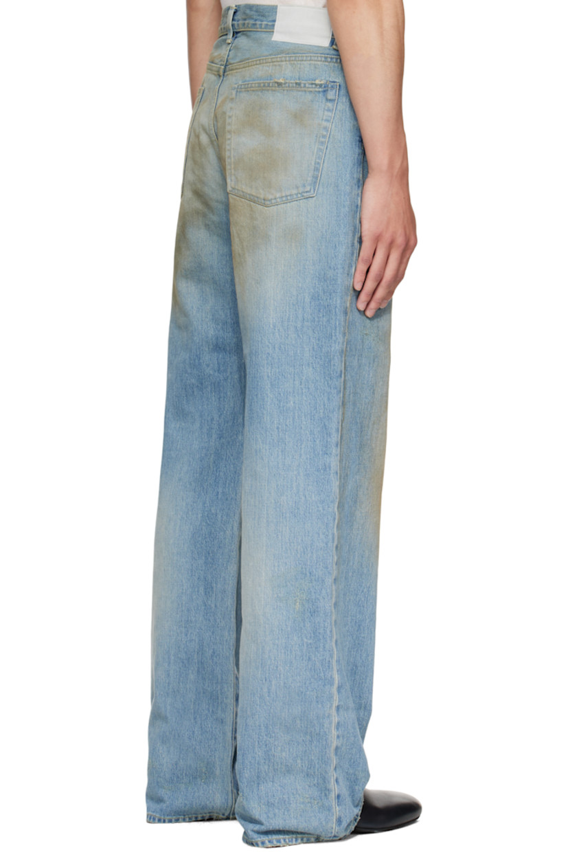Non-stretch denim jeans.

· Fading, whiskering, smudging, and distressing throughout 
· Flared
· Belt loops
· Five-pocket styling 
· Button fly 
· Suede patch at back waistband
· Contrast stitching in yellow 

Supplier color: Indigo