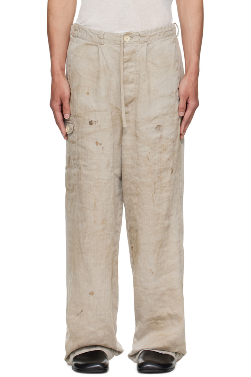 Heavyweight linen herringbone trousers. 

· Smudging and fading throughout 
· Concealed drawstring at elasticized waistband 
· Belt loops
· Four-pocket styling
· Zip fly 
· Flap pocket at outseam

Supplier color: Natural