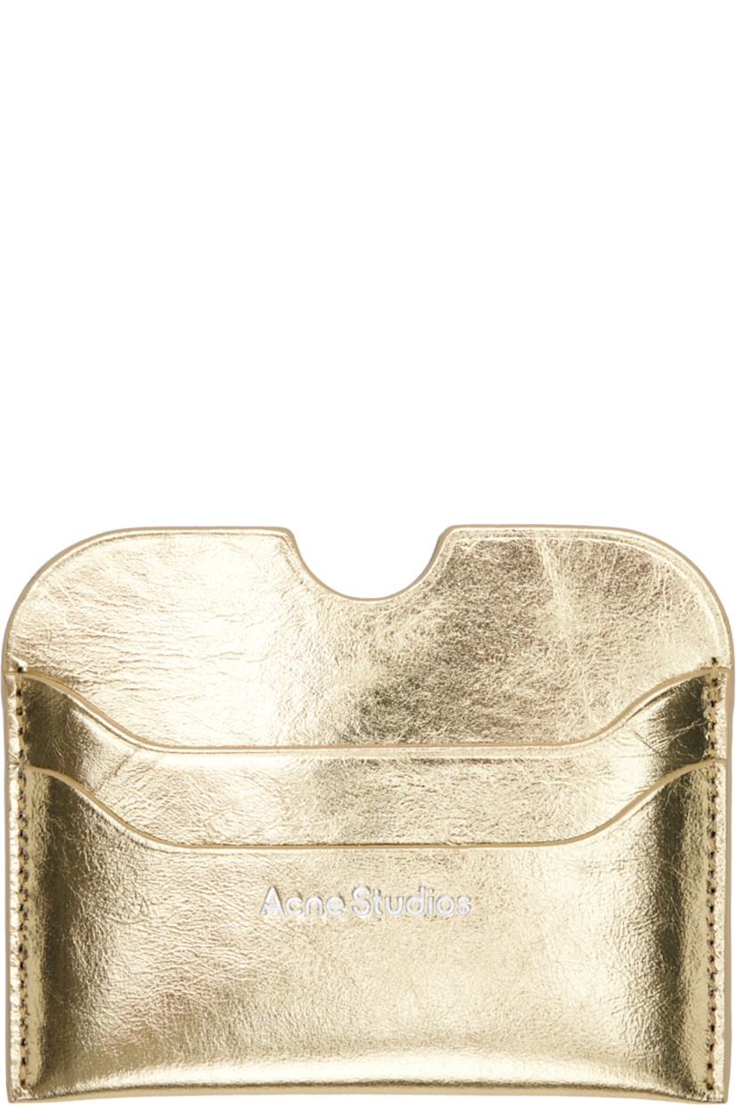Crinkled leather card holder.

· Logo embossed at face
· Four card slots
· Central note slot
· H3" x W4"

Supplier color: Gold