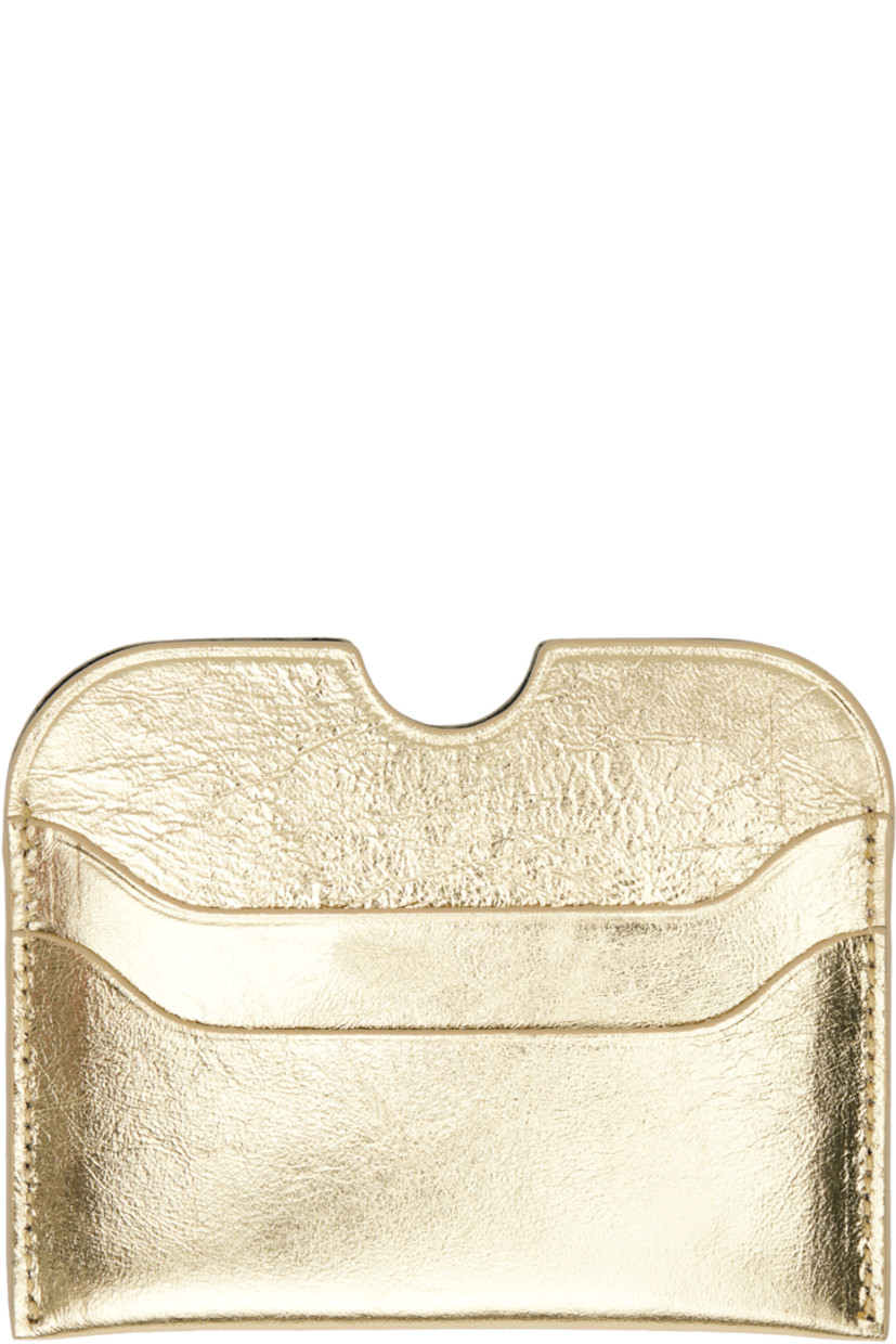 Crinkled leather card holder.

· Logo embossed at face
· Four card slots
· Central note slot
· H3" x W4"

Supplier color: Gold