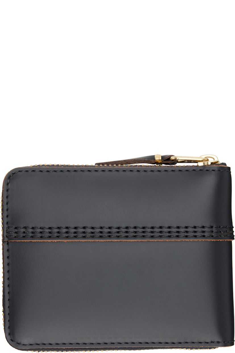 Buffed leather bifold wallet.

· Topstitching at face and back face
· Zip closure
· Three card slots
· One patch pocket and note slot
· Flap coin compartment
· H3.25" x W4.25" x D1"

Supplier color: Black