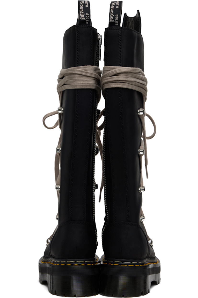 Knee-high buffed leather boots.

· Wraparound lace-up closure
· Extended tongue
· Pull-loop at heel collar
· Zip closure at inner side
· Yellow stitching at heat-sealed Goodyear welt
· Treaded Air Cushion rubber platform sole
· Platform: H2"

Part of the Rick Owens x Dr. Martens collaboration.

Supplier color: Black
