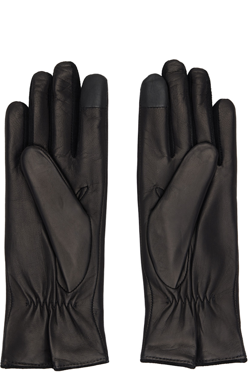 Grained nappa leather gloves.

· Suede trim at fingers
· Partially elasticized wrist
· Notch and logo hardware at top wrist
· Full knit cashmere-blend lining

Supplier color: Black