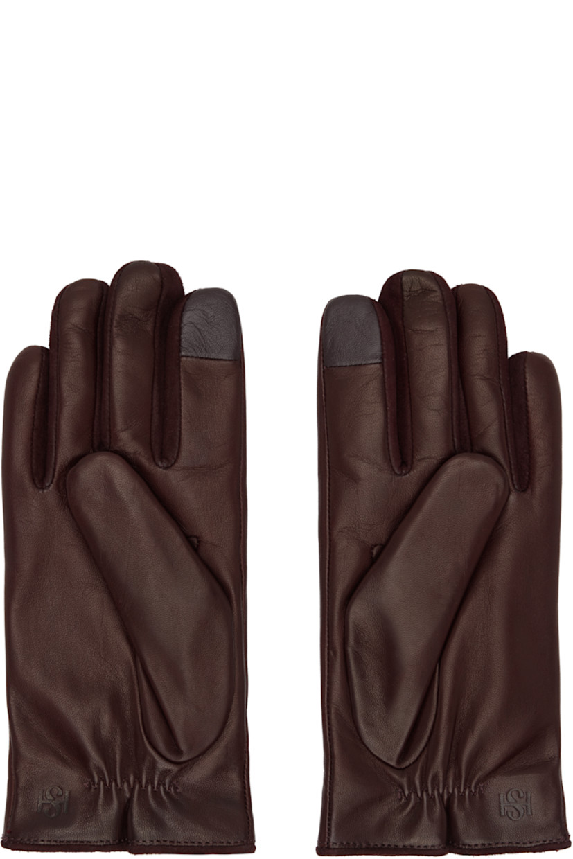 Grained nappa leather gloves.

· Suede trim at fingers
· Partially elasticized wrist
· Notch at top wrist
· Embossed logo at back wrist
· Full knit cashmere-blend lining

Available exclusively at SSENSE.

Supplier color: Vino