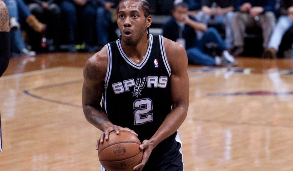 A basketball player attempts a shot