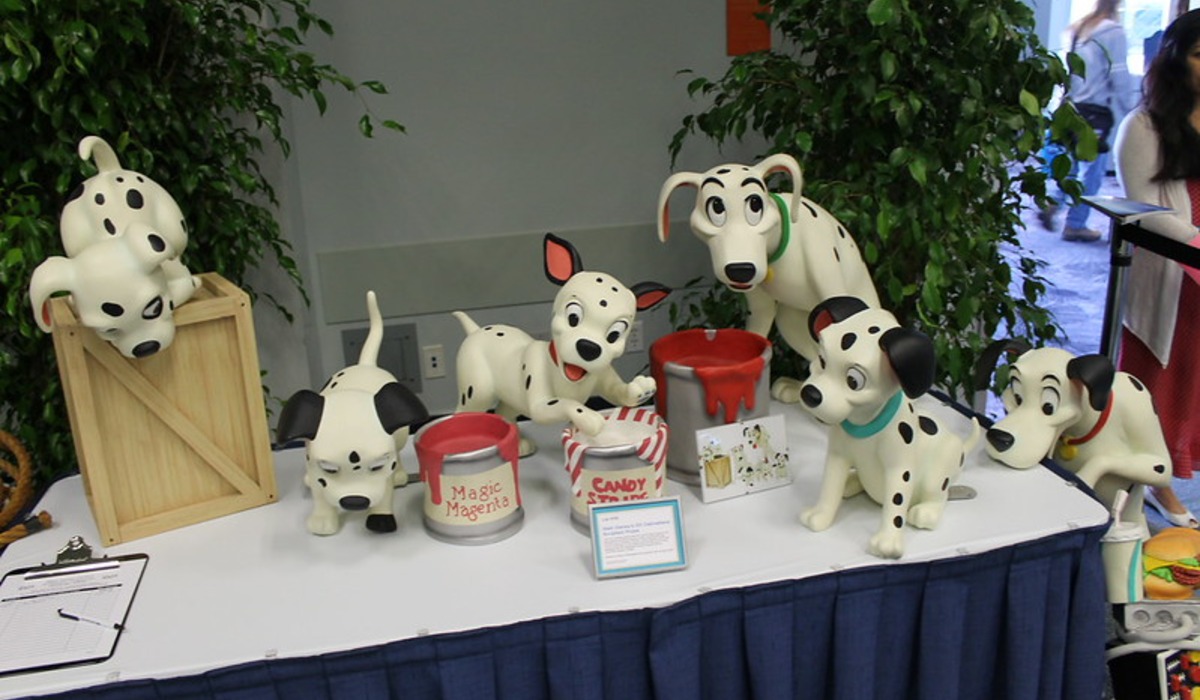 a dalmatian dog standing in a field of tall grass