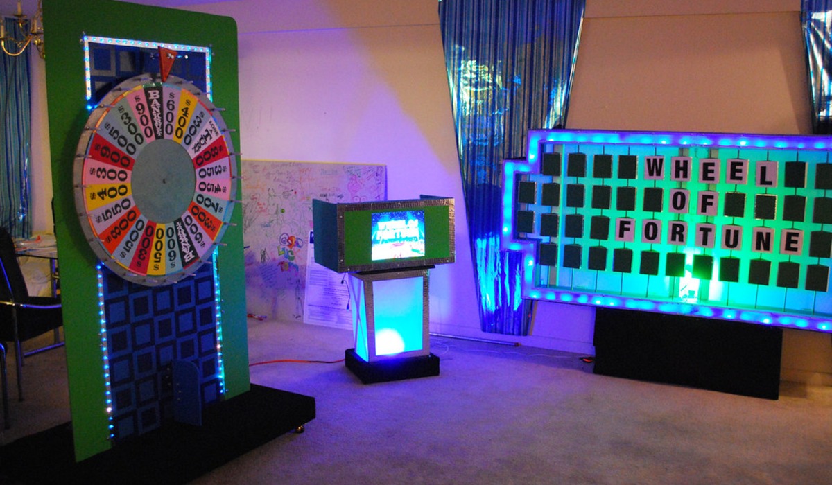 a woman standing in front of a wheel of fortune