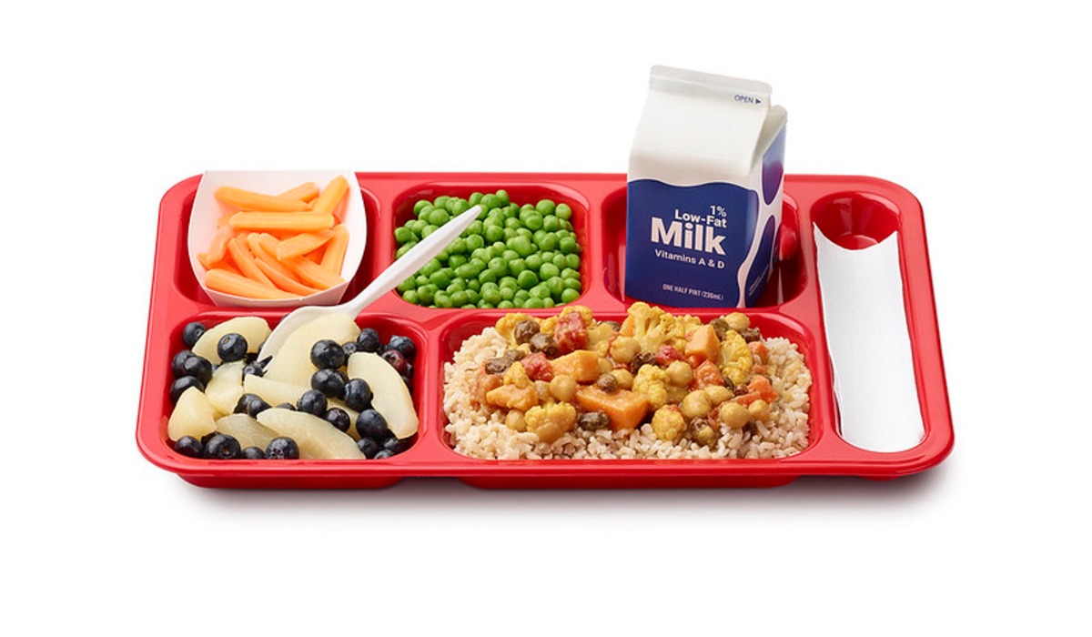 brown and white plastic food container on brown wooden table