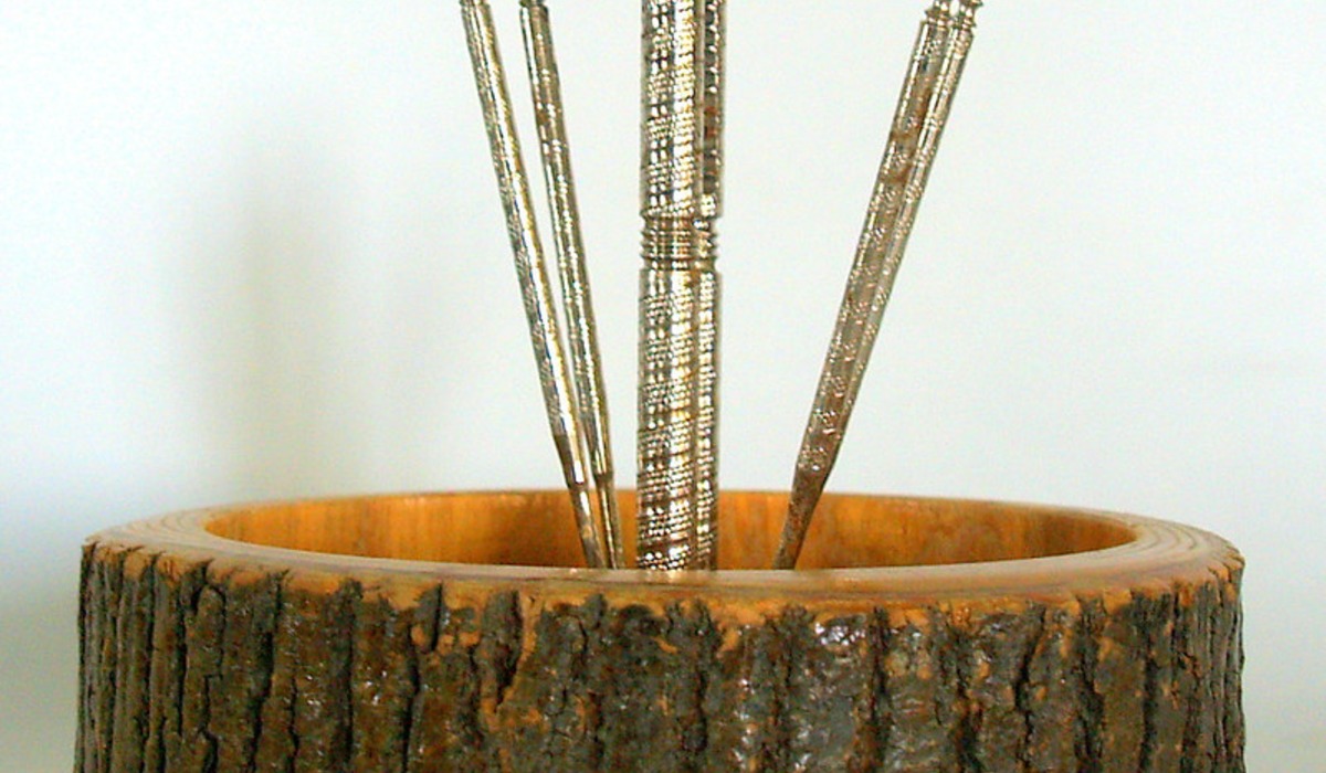 a wooden bowl filled with nuts on top of a wooden table