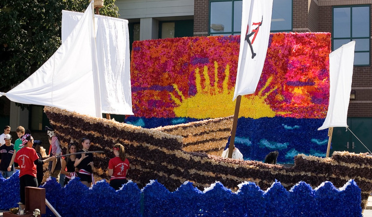 Parade floats with "charity" and "hope faith" displayed