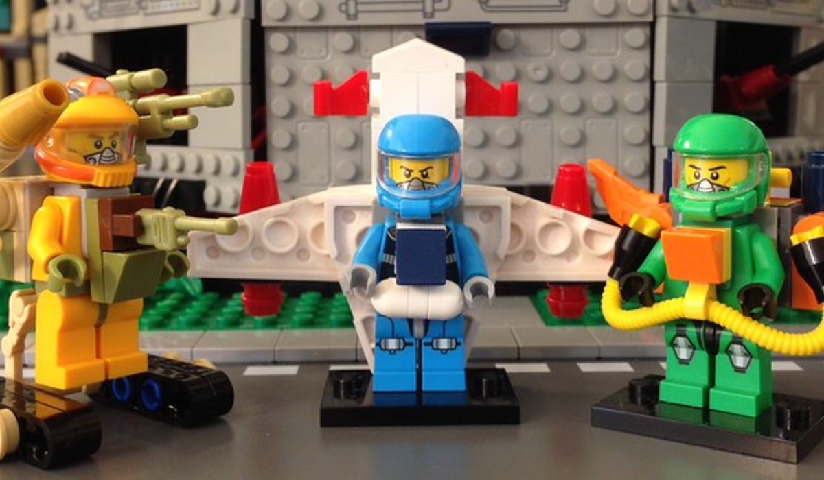 three men in riot armor near buildings