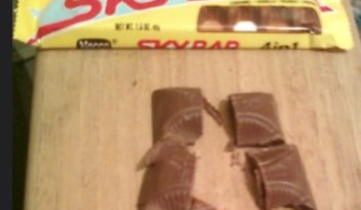 Candy bars displayed in a vending machine slots
