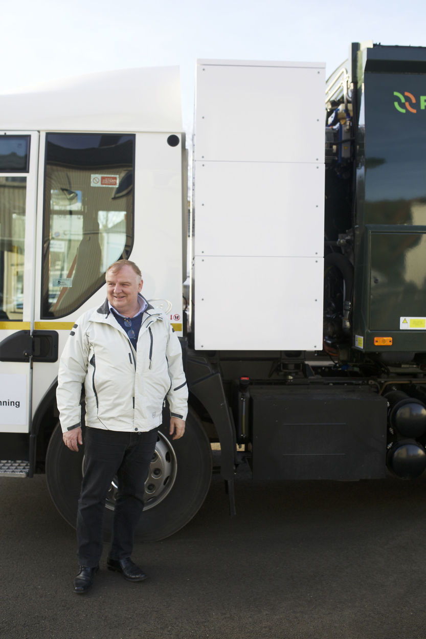 Brian Olesen fra Phoenix Danmark viser fram de tre batteripakkene på el-søppelbilen. Foto: Christian Nicolai Bjørke