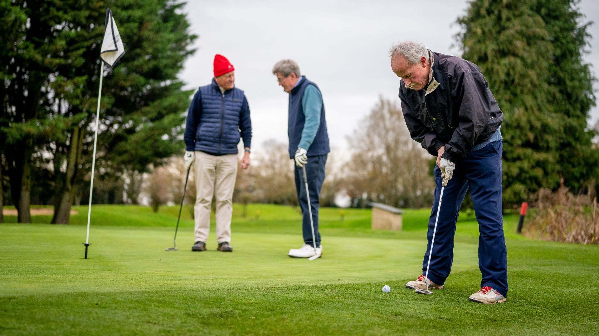 old man learning to hit the golf ball