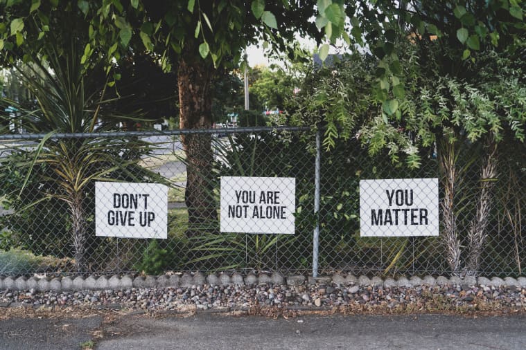 Three banners with inspirational messages: don't give up, you are not alone, and you matter.