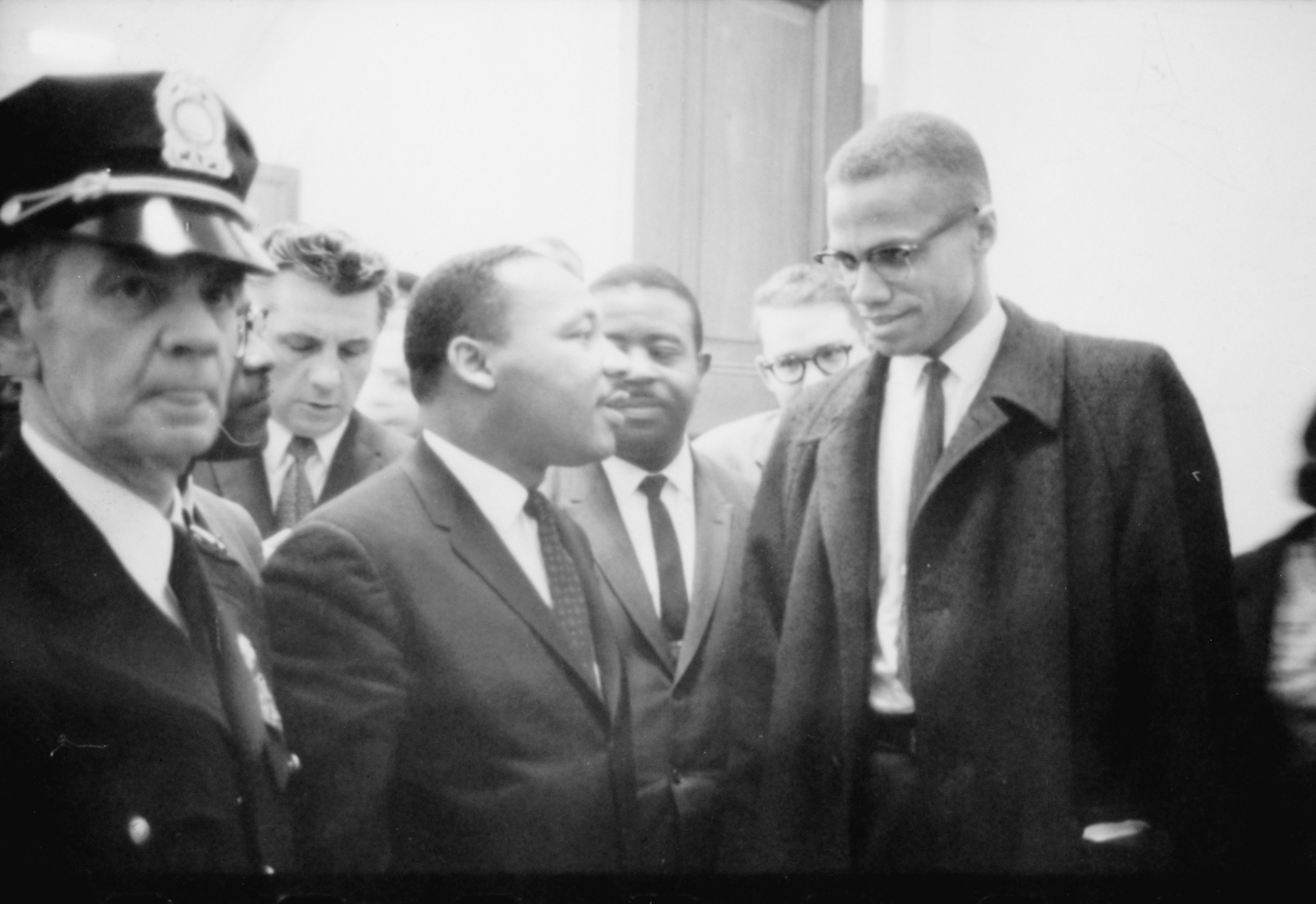 Martin Luther King and Malcom X chatting before a press conference in 1964.