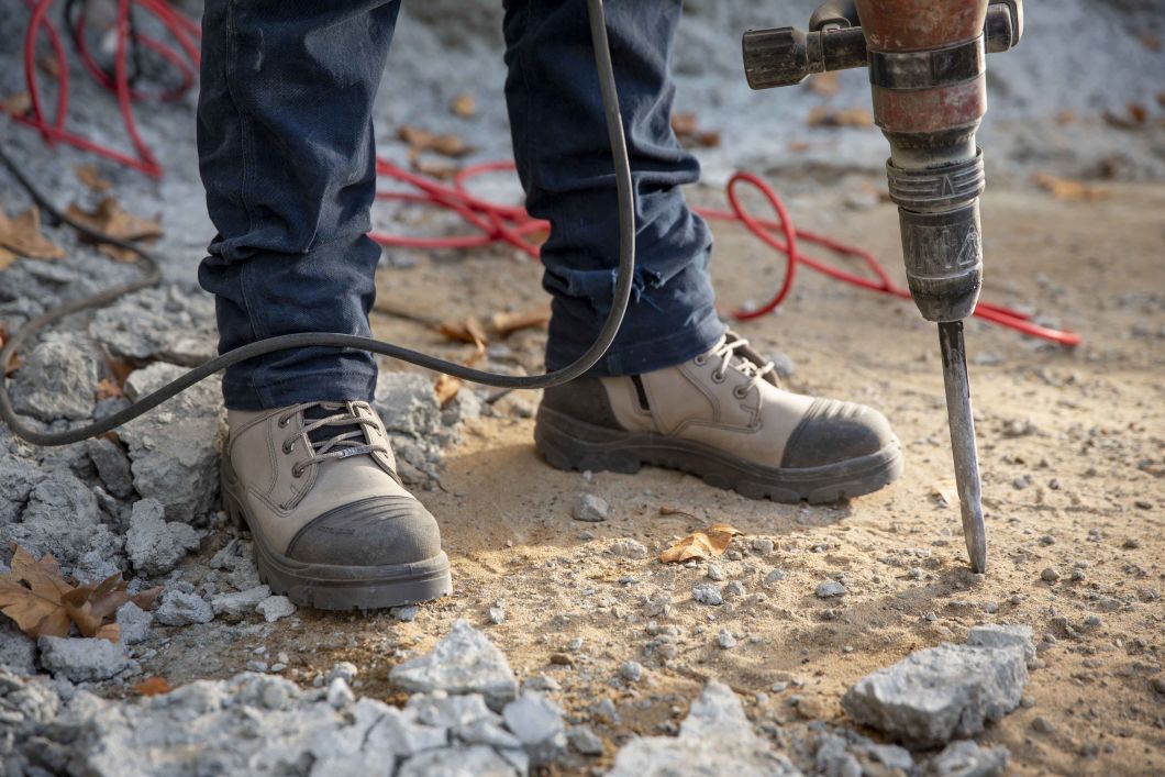 jackhammer worker wearing steel blue boots