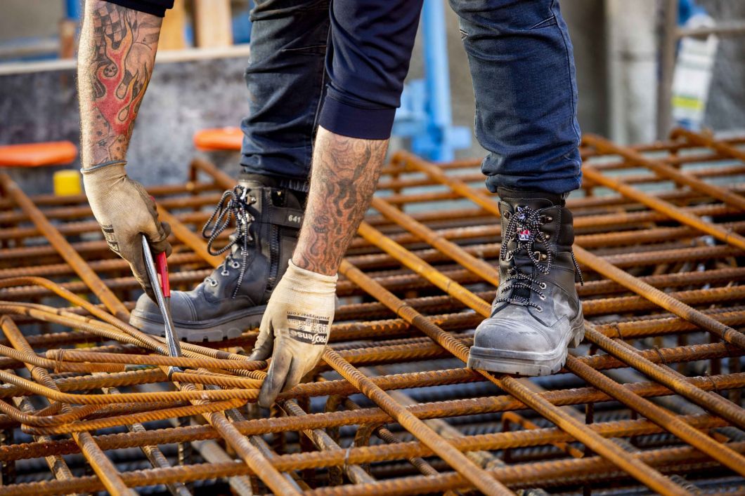 tradie wearing black construction work boots