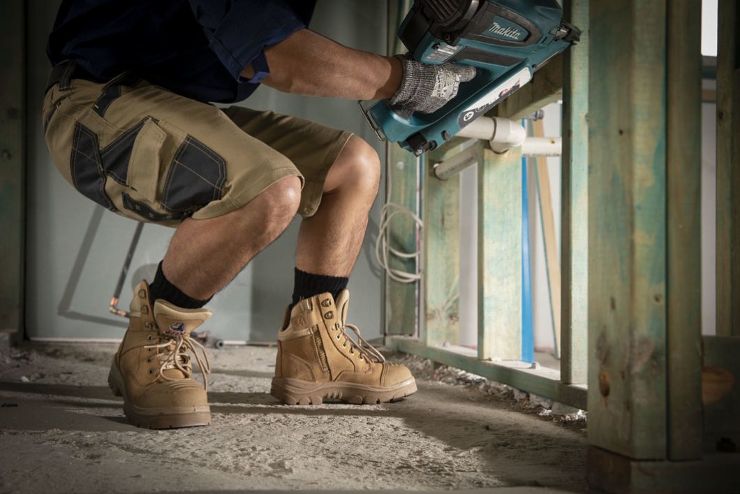 Man crouched down with Beige boots