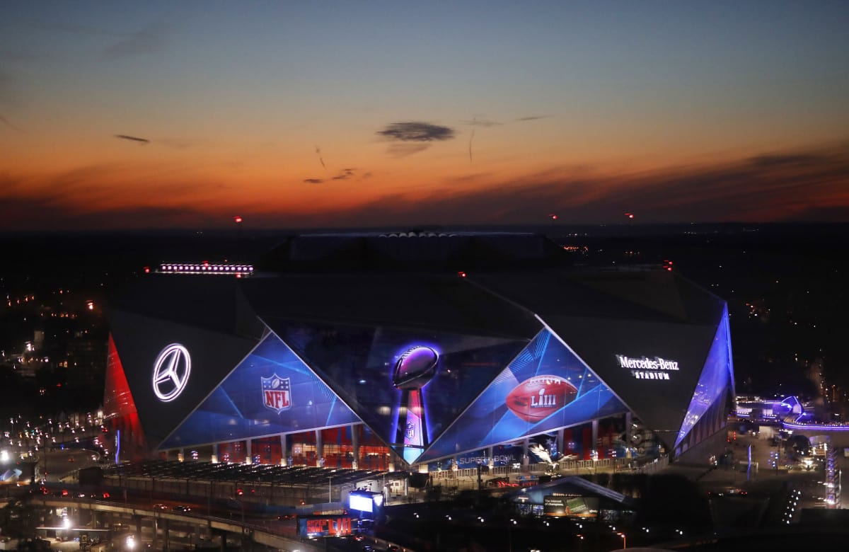 The sun sets behind Mercedes-Benz Stadium ahead of Sunday's NFL Super Bowl 53 football game between the Los Angeles Rams and New England Patriots in Atlanta, Wednesday, Jan. 30, 2019. (AP Photo/David Goldman)