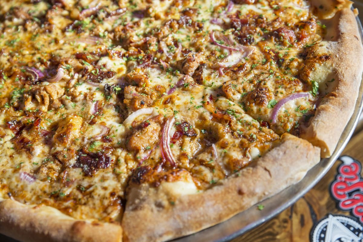 The Hog Heaven pizza at Evel Pie is made with man candy bacon, pulled pork, red onions, parsley, smoked mozzarella and barbecue sauce. (Benjamin Hager/Las Vegas Review-Journal)