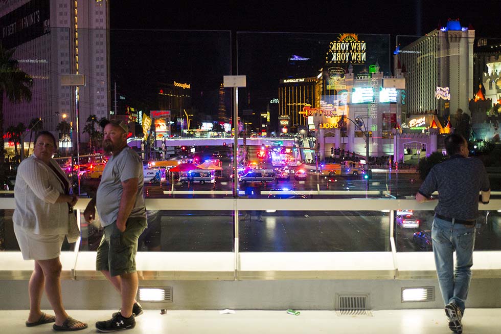 People watch from a pedestrian bridge as Las Vegas police respond during an active shooter situation on the Las Vegas Strip near Tropicana Avenue in Las Vegas on Sunday, Oct. 1, 2017. Chase Stevens Las Vegas Review-Journal