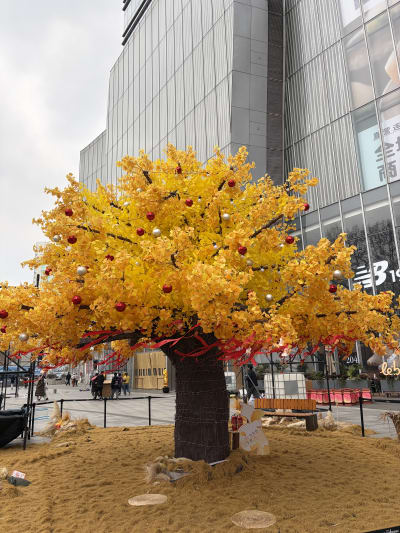 A golden tree with red and white balls hanging on it