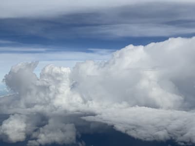 Thick fluffy clouds under a clear blue sky